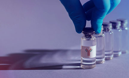 a photo of glass vials arranged in a line, with a gloved hand holding the first vial